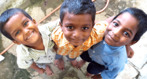 photo of three boys embracing and looking up