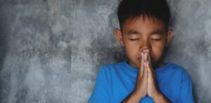 image of boy in prayer