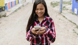 image of youth texting on cell phone