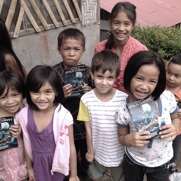 photo of kids holding the story of Jesus leaflet