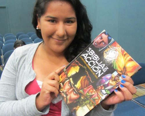photo of young teen holding the action bible