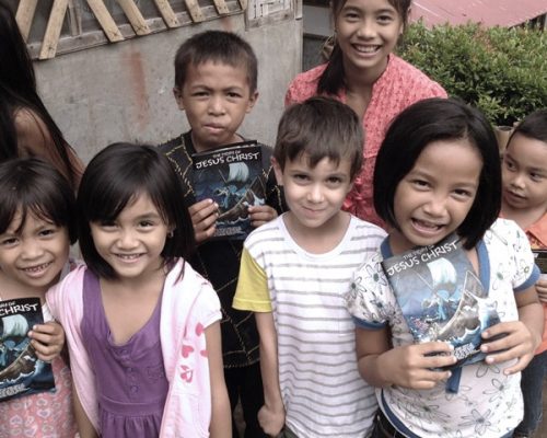 photo of kids holding the story of Jesus leaflet